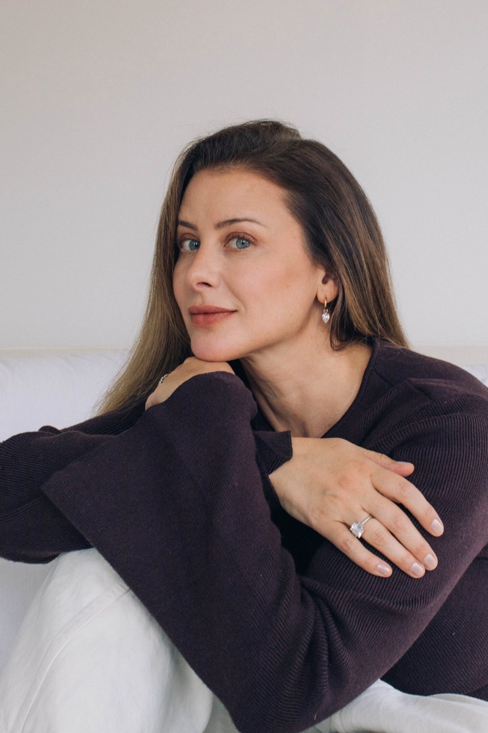 Lo Bosworth Natale at home in a plum sweater