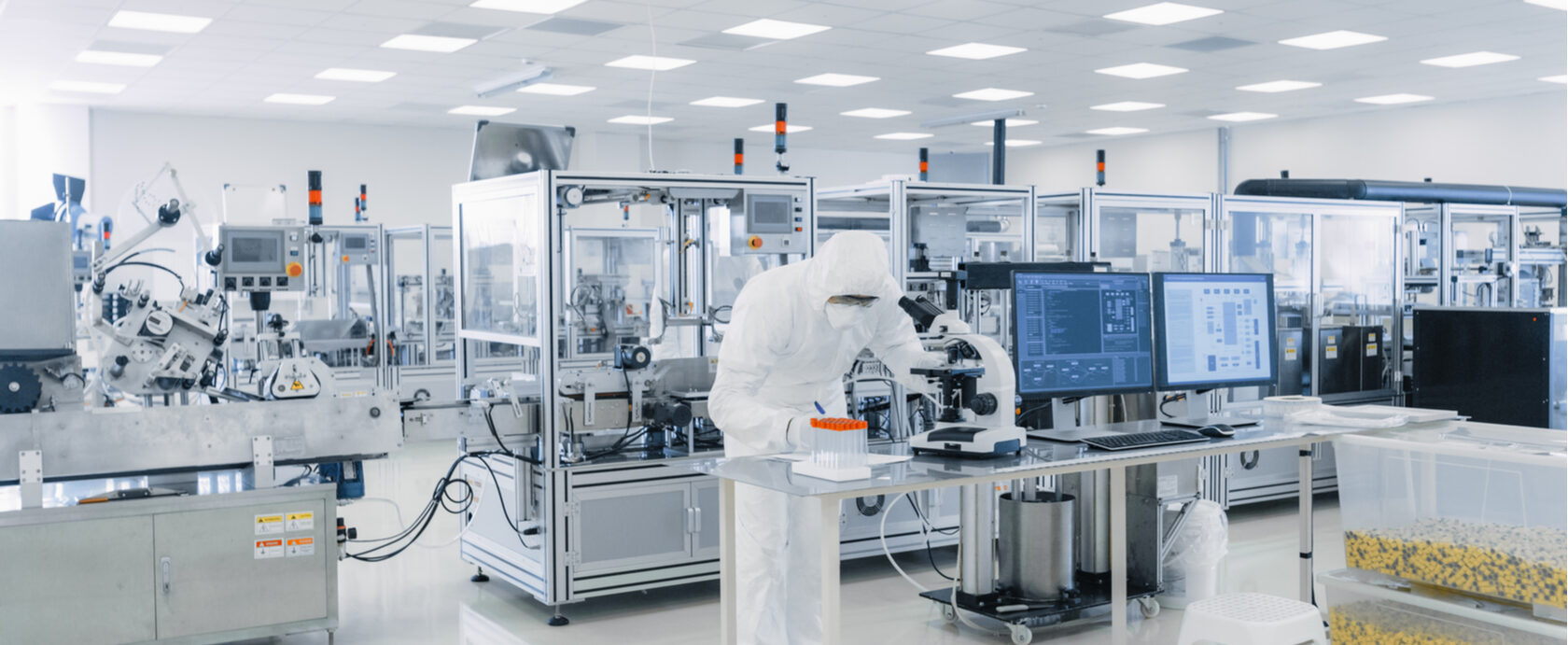 Analyst working at a microscope in a clean laboratory