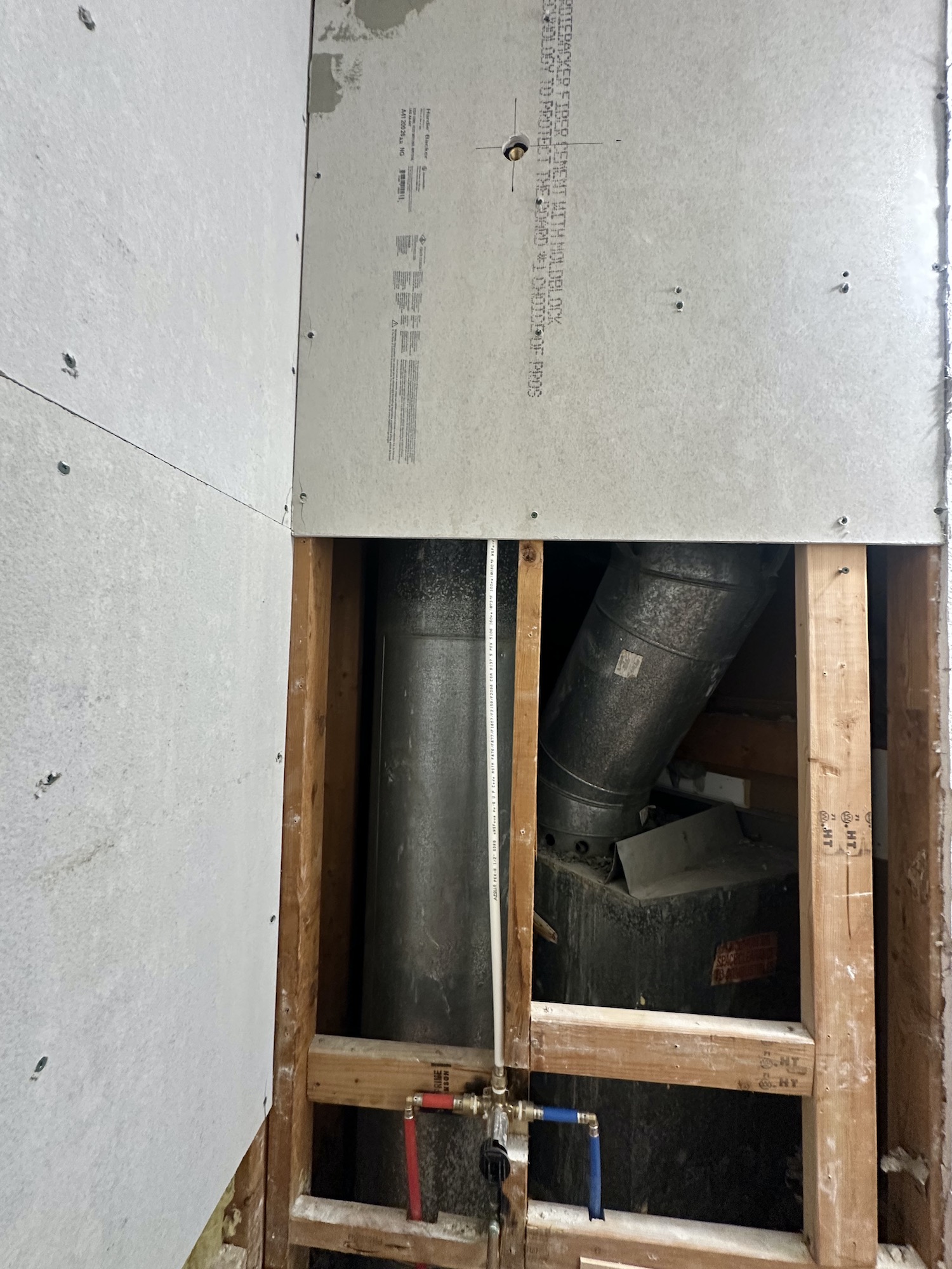 Bathroom wall preparation with cement backer board installed before tile