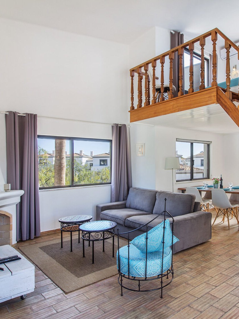 The living room with a staircase to the mezzanine
