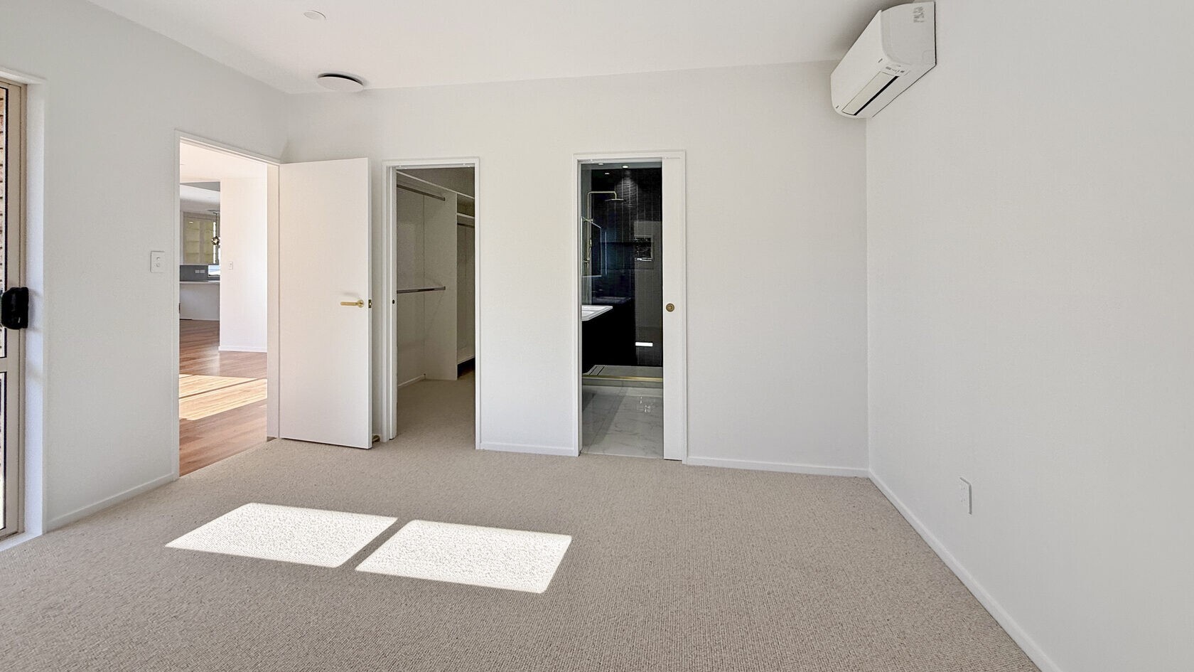 Renovated ground-floor master bedroom with doors to the wardrobe and ensuite