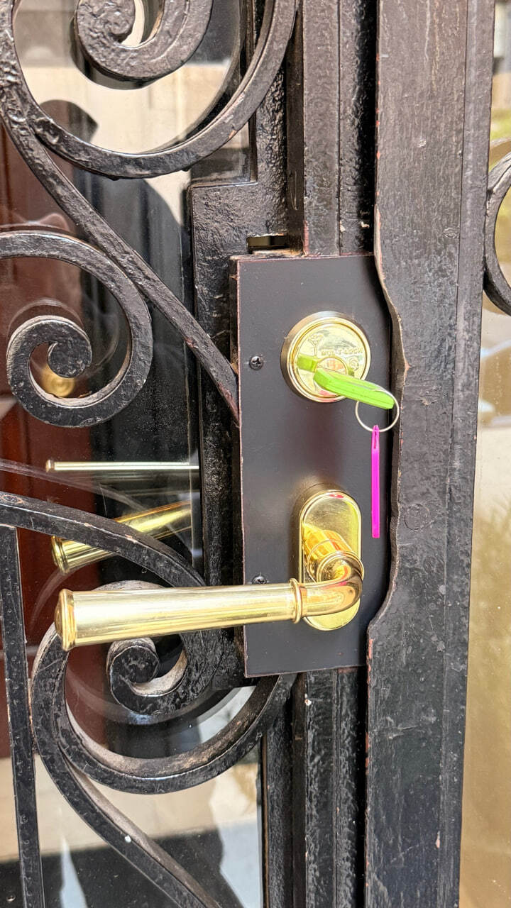 Ornate ironwork security gate with Mul-T-Lock hardware on an NYC row house, serviced by LexKey Locksmith LLC