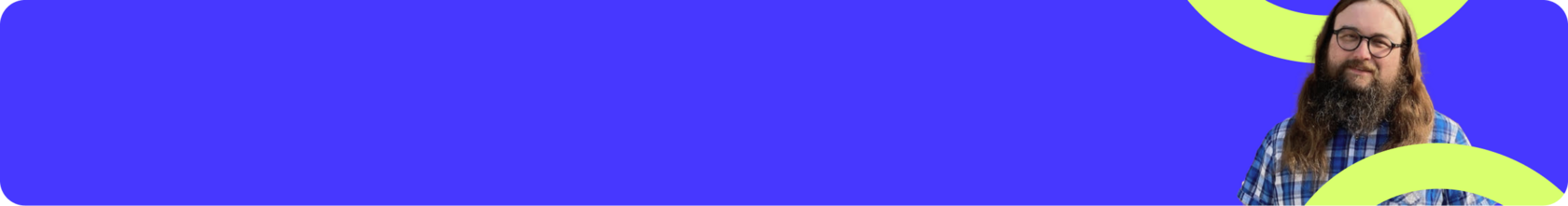 Long-haired man (Steve Baker) in glasses with a beard and moustache smiling at us warmly.