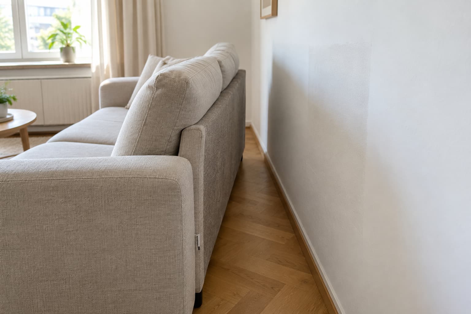 Sofa mit Abstand zur frisch sanierten Außenwand und Luftentfeuchter im Raum – Polsterreinigung nach Schimmelsanierung in Frankfurt