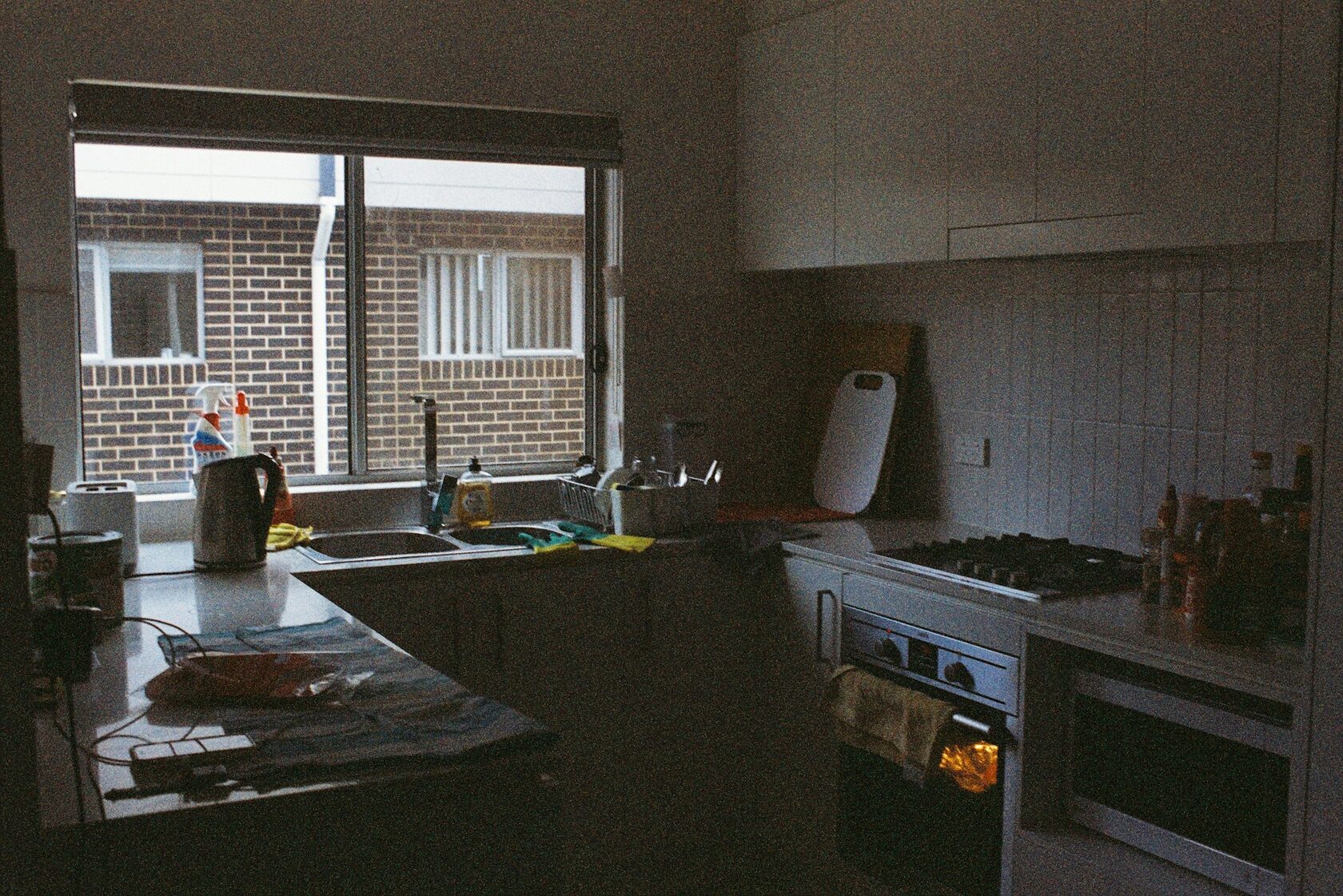 Kitchen before renovation, dated cabinets, dim lighting