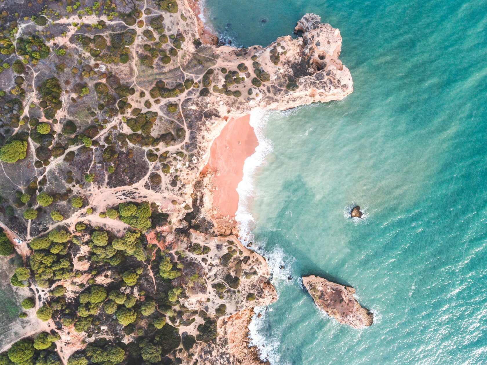 Aerial view of the Algarve coast, with beach, cliffs and sea
