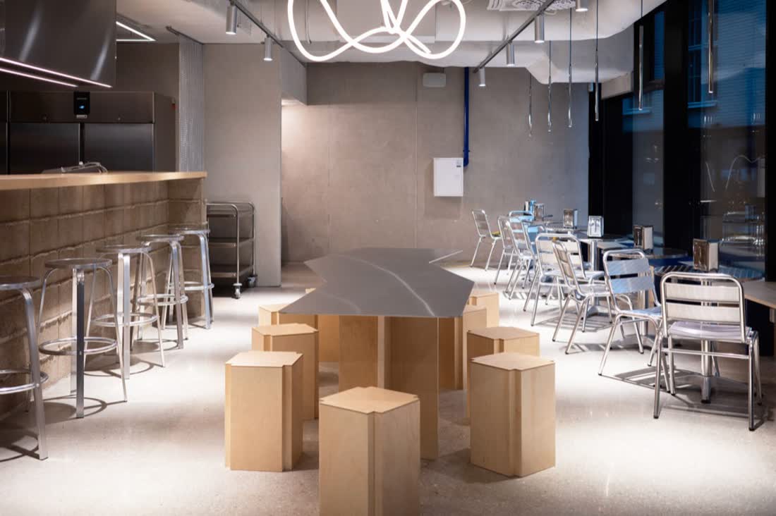 Bar room with stools and a steel counter