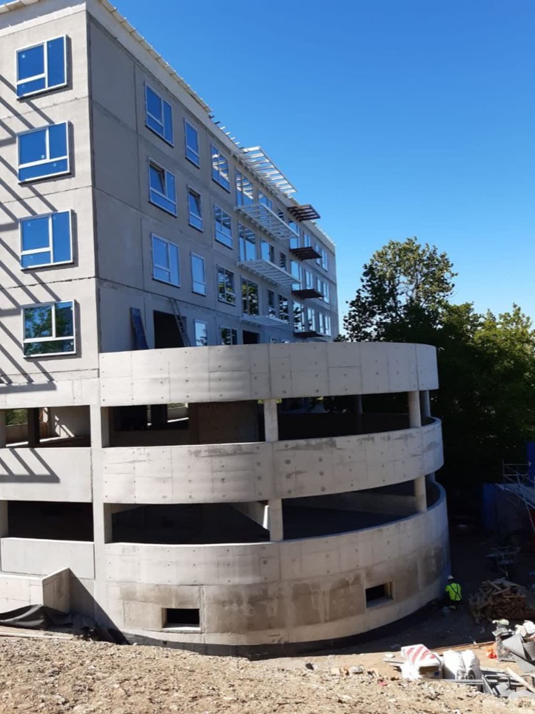 Finished building with a curved concrete facade