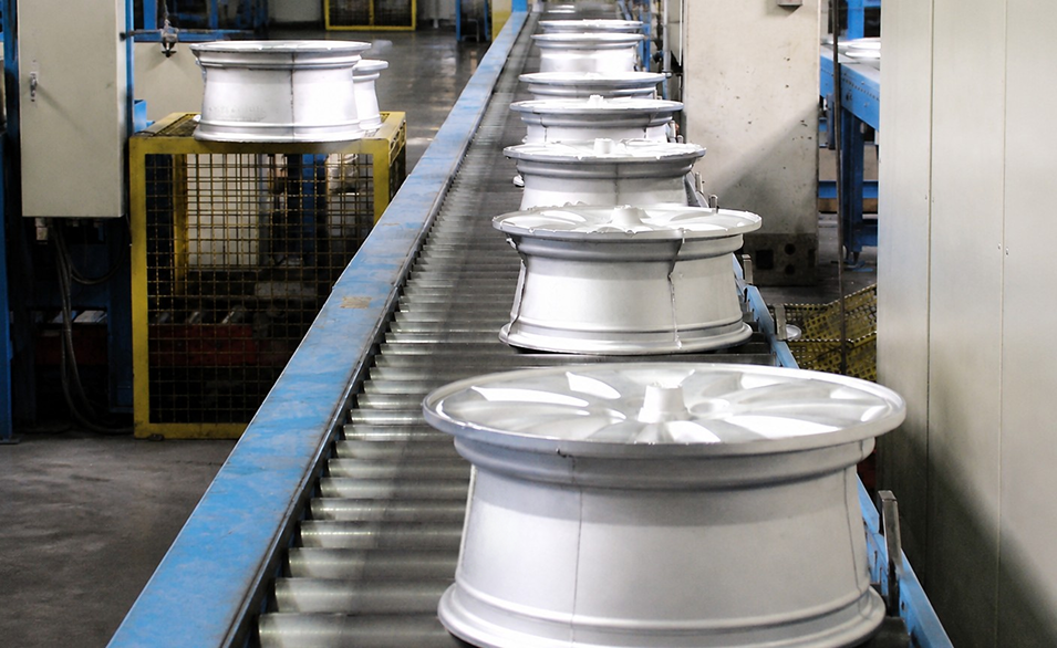 Aluminum wheels moving along a production conveyor