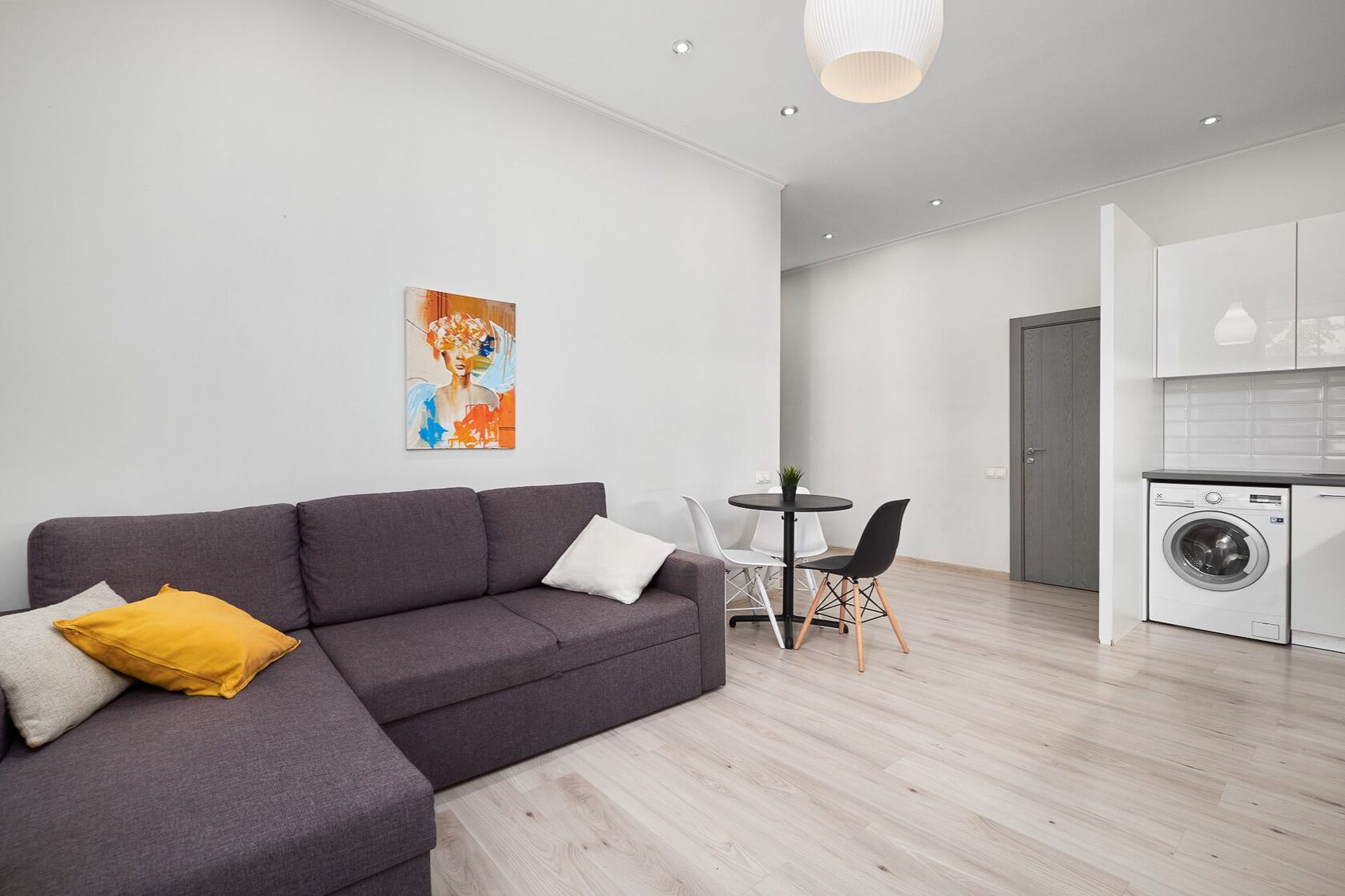 Apartment living room with sofa and artwork at Lāčplēša iela 53