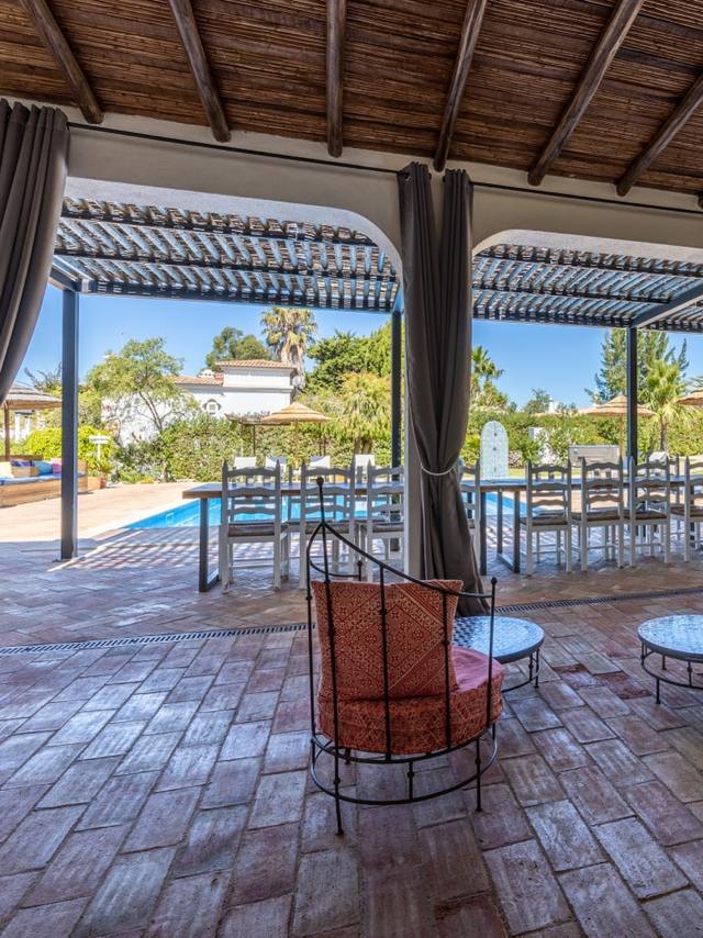 The covered dining terrace by the pool