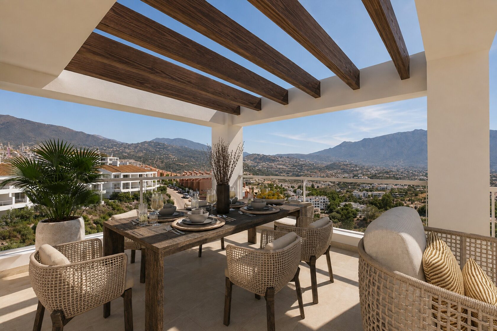 Terrace laid for dining, with the mountains beyond