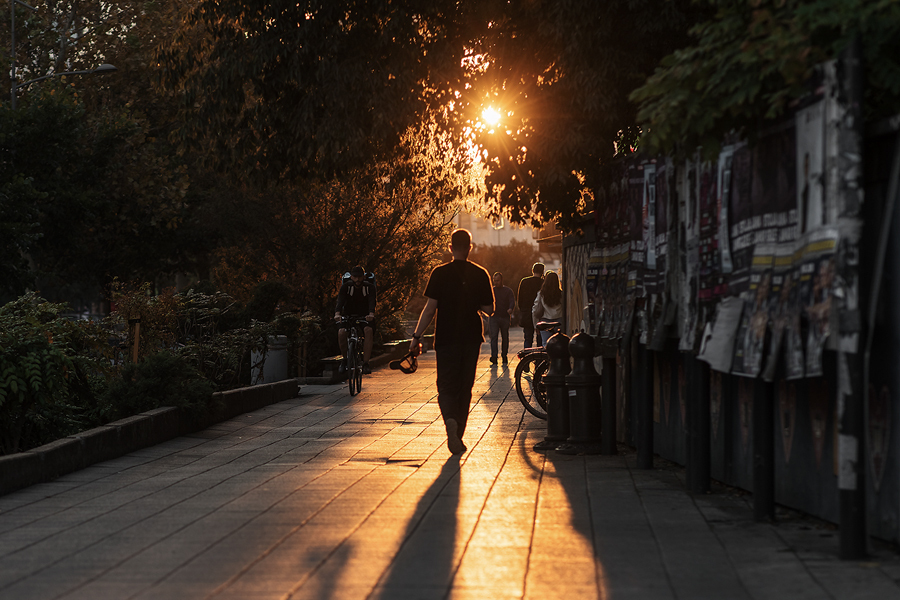 Street scene at sunset with photographers and cyclists