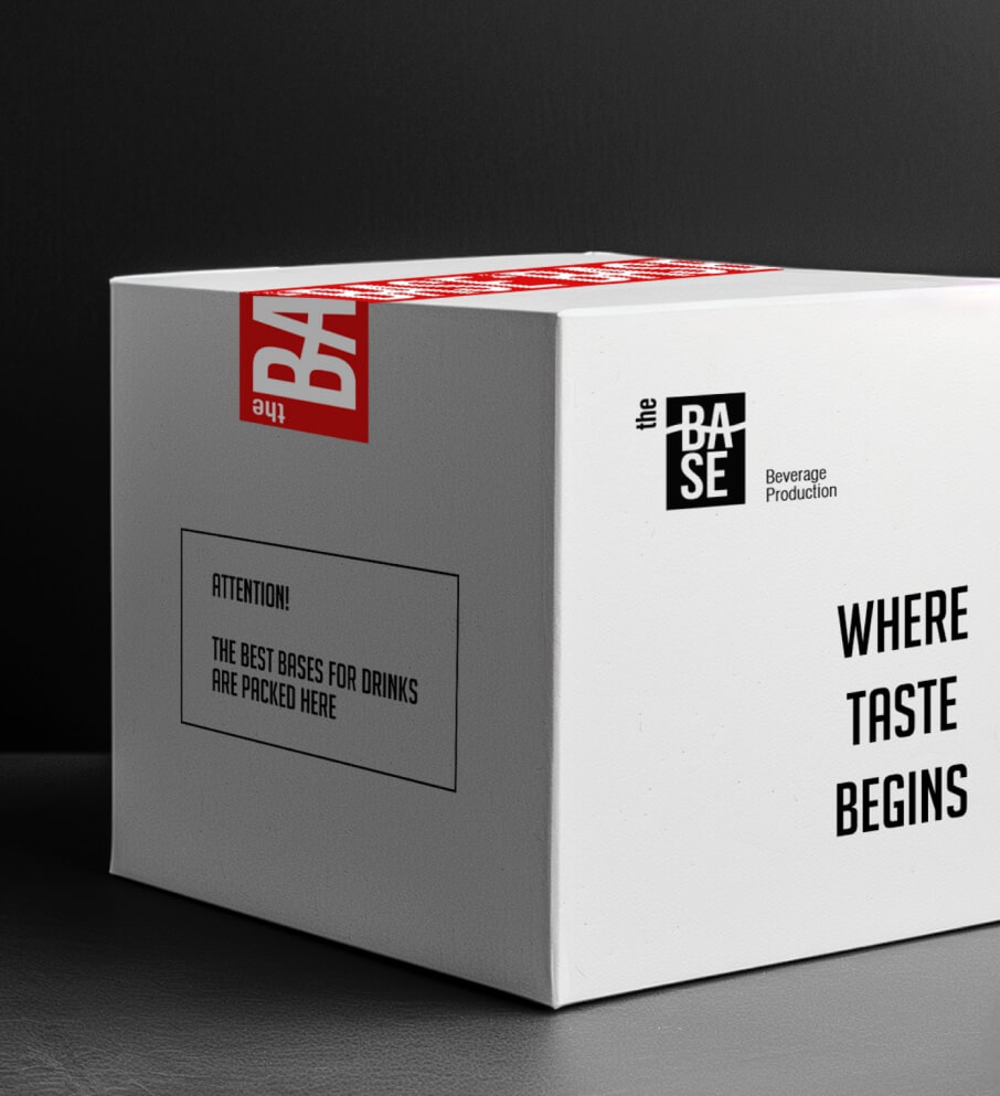The Base Beverage branded shipping box marked Where Taste Begins, held in the production facility
