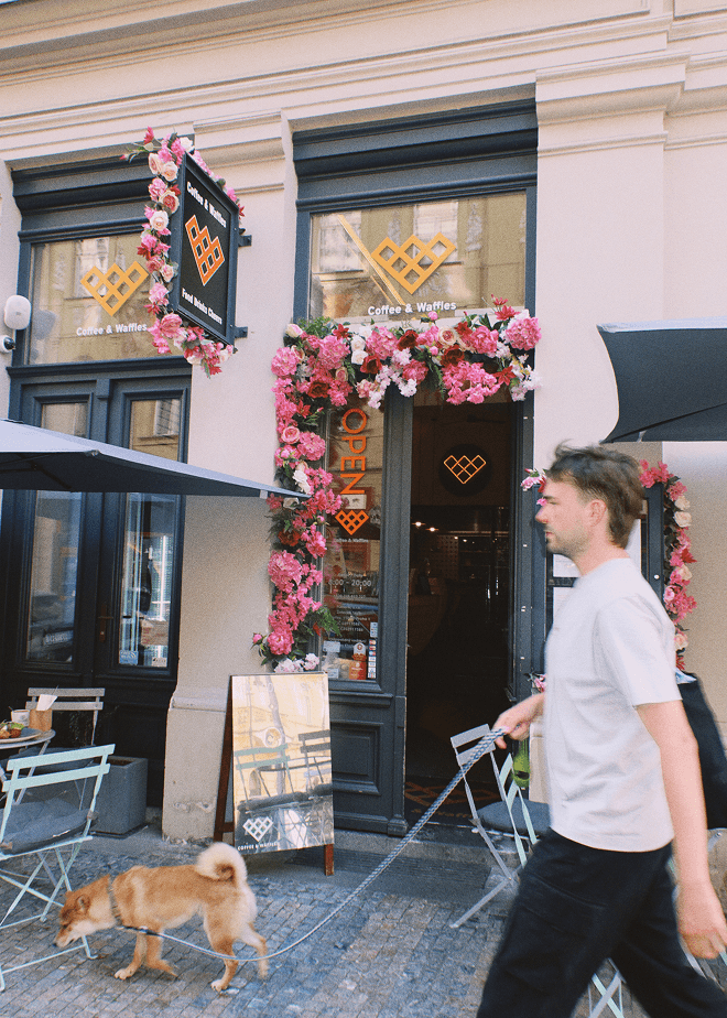 Entrance of Coffee & Waffles café with flowers