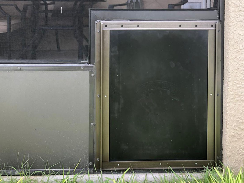 Pet door installed in pool enclosure screen
