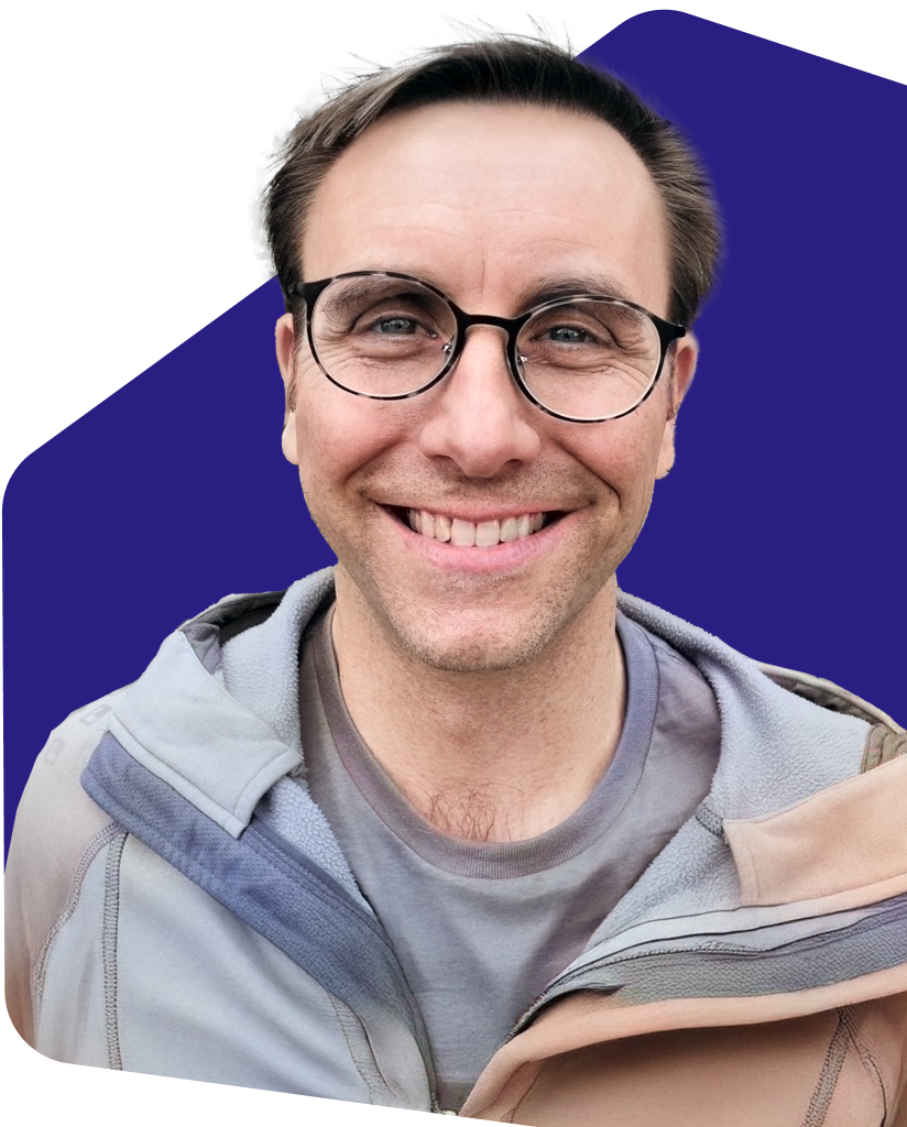 The photo of Bernard Banta, black man wearing glasses and light blue shirt.